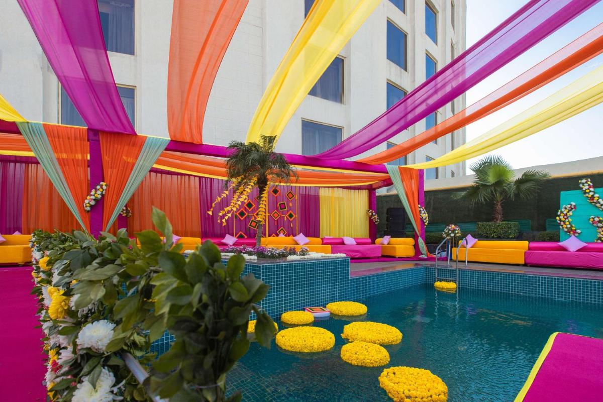 a pool in a hotel with colorful decorations at Radisson Blu Hotel New Delhi Dwarka in New Delhi a pool in a hotel with colorful decorations at Radisson Blu Hotel New Delhi Dwarka in New Delhi
