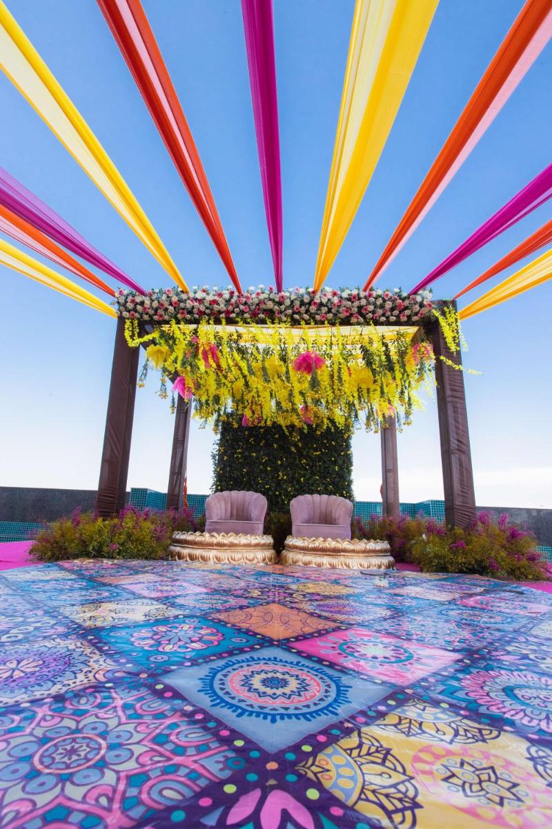 an indian wedding altar with flowers and chairs at Radisson Blu Hotel New Delhi Dwarka in New Delhi an indian wedding altar with flowers and chairs at Radisson Blu Hotel New Delhi Dwarka in New Delhi