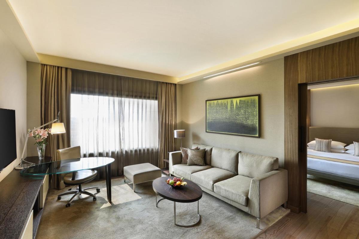 a living room with a couch and a table at Hyatt Regency Delhi in New Delhi a living room with a couch and a table at Hyatt Regency Delhi in New Delhi