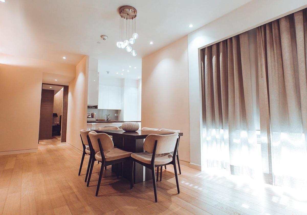 a dining room with a black table and chairs at Hyatt Regency Delhi in New Delhi a dining room with a black table and chairs at Hyatt Regency Delhi in New Delhi