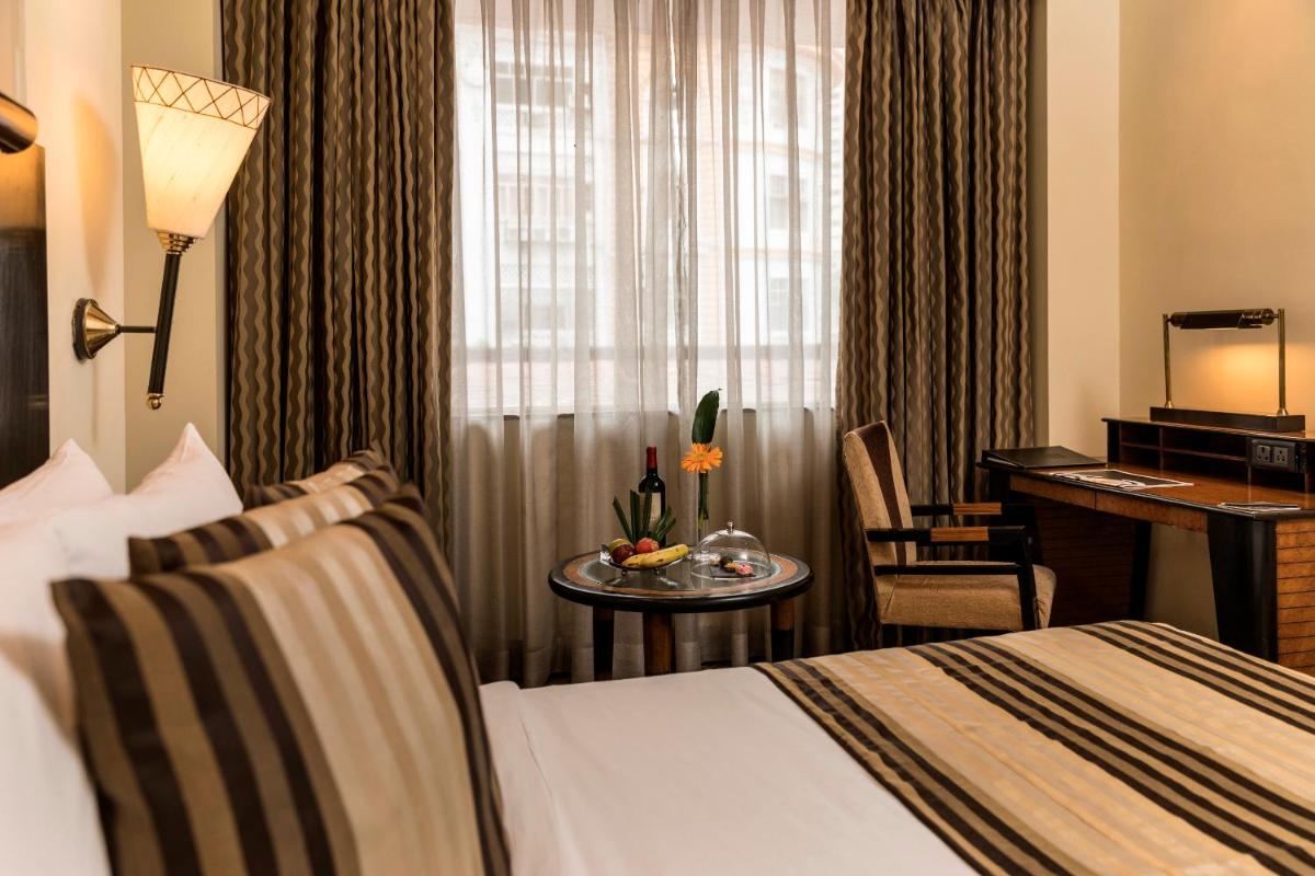 a hotel room with a bed and a desk at The Park Kolkata in Kolkata