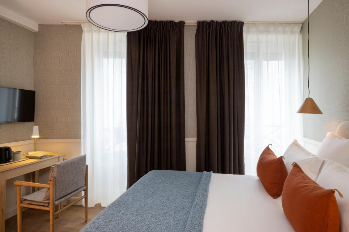 Un ou plusieurs lits dans un hébergement de l'établissement Le Petit Oberkampf Hotel & Spa