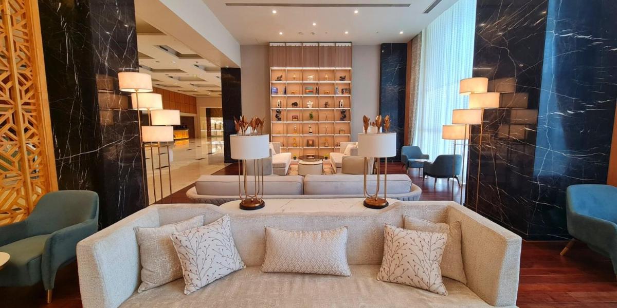 a lobby with a couch and chairs and a wine cellar at InterContinental Jaipur Tonk Road by IHG in Jaipur