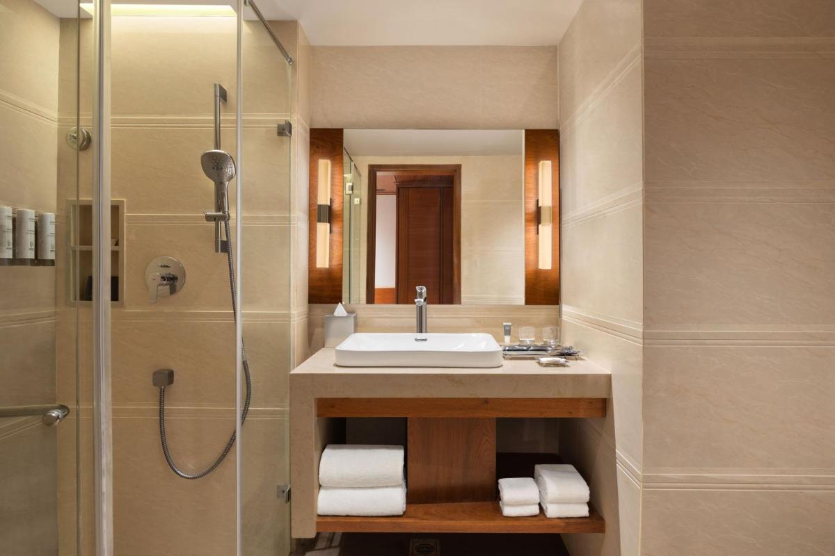 a bathroom with a sink and a shower at Courtyard by Marriott Tiruchirappalli in Tiruchchirāppalli