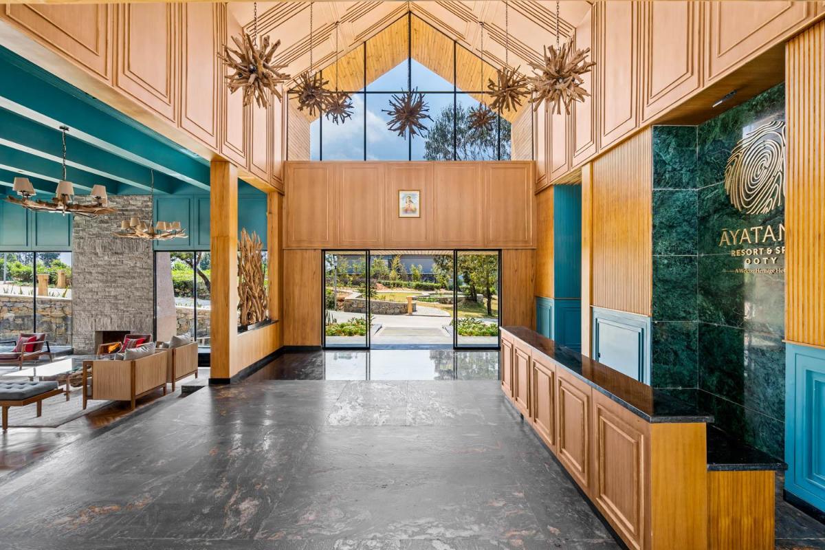 an open lobby with a large glass entry door at WelcomHeritage Ayatana Ooty in Ooty