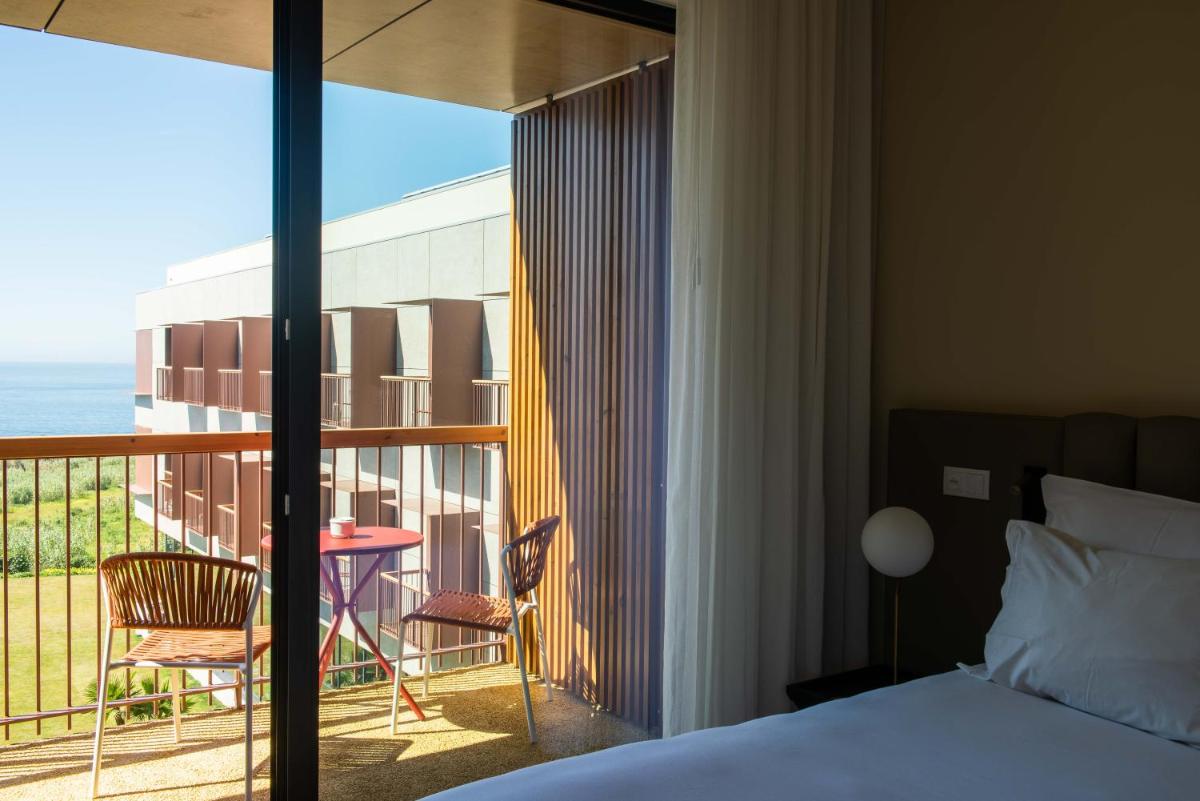 Uma cama ou camas num quarto em Sines Sea View Business & Leisure Hotel