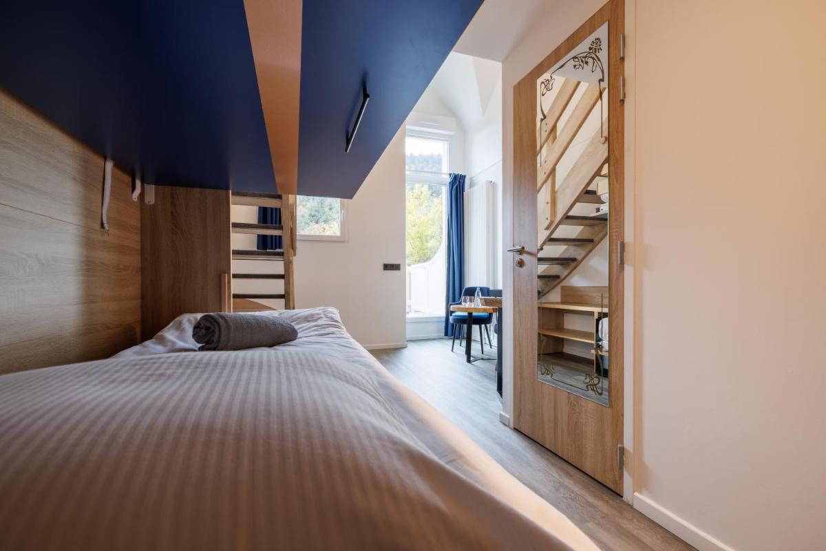 Un ou plusieurs lits dans un hébergement de l'établissement Hotel SPA Husseren Collections - Proche Colmar - Eguisheim
