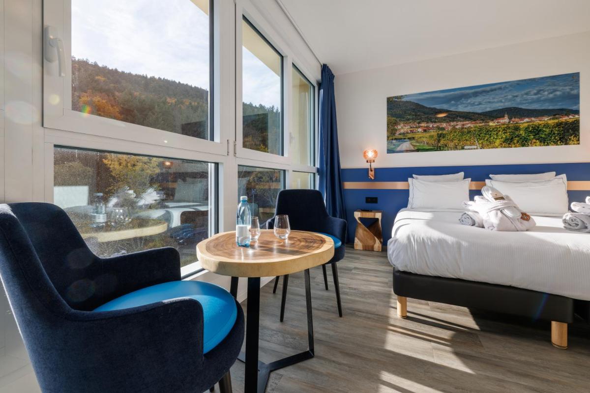 Un ou plusieurs lits dans un hébergement de l'établissement Hotel SPA Husseren Collections - Proche Colmar - Eguisheim