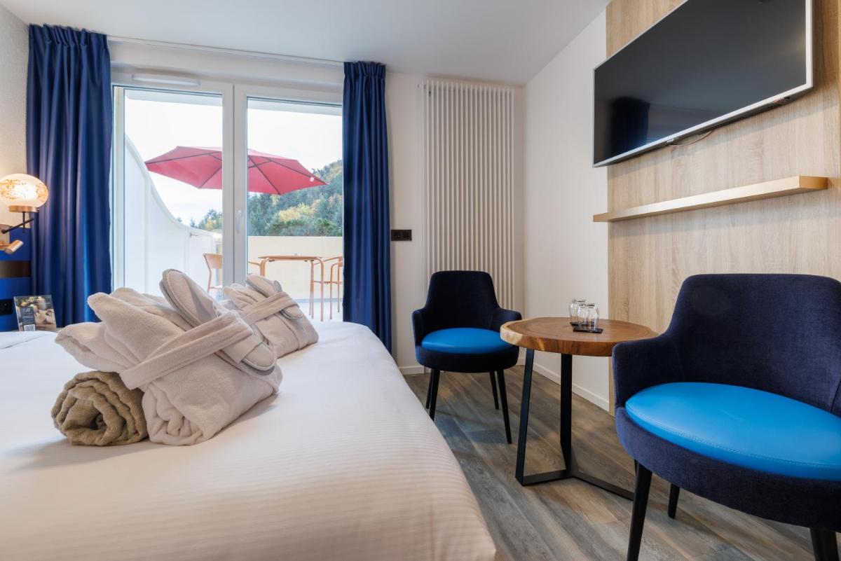 Un ou plusieurs lits dans un hébergement de l'établissement Hotel SPA Husseren Collections - Proche Colmar - Eguisheim