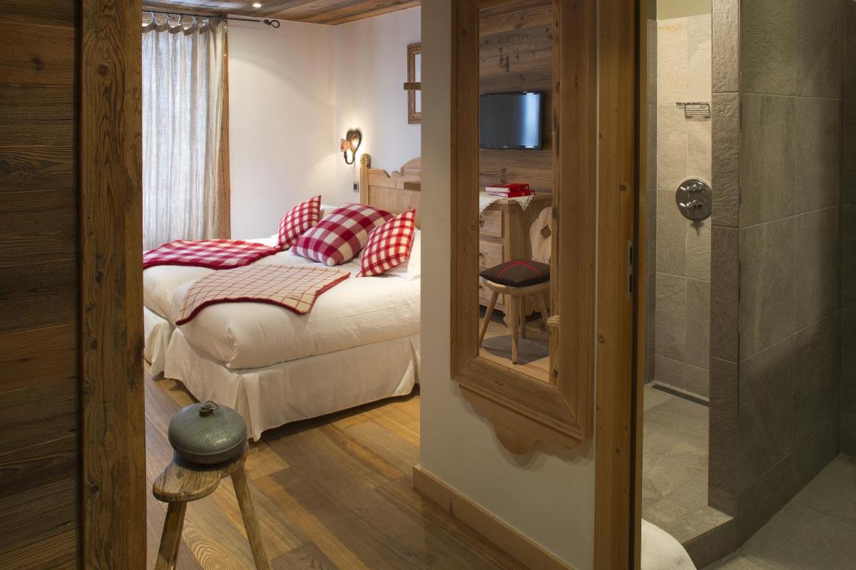 Un ou plusieurs lits dans un hébergement de l'établissement Chalet-Hôtel Hermitage