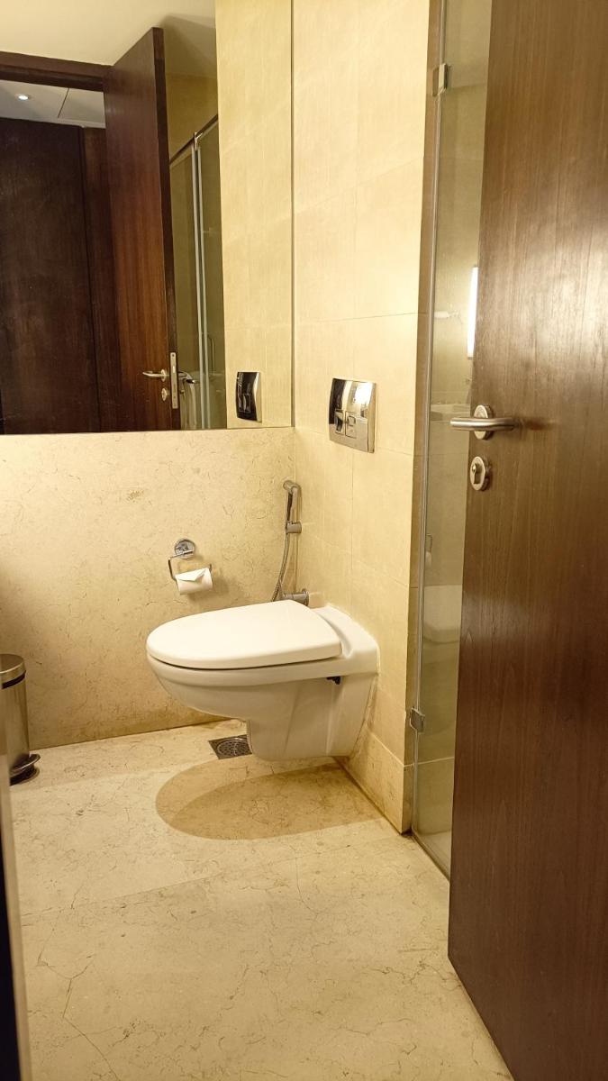 a bathroom with a toilet and a sink and a shower at Marasa Sarovar Premiere in Tirupati