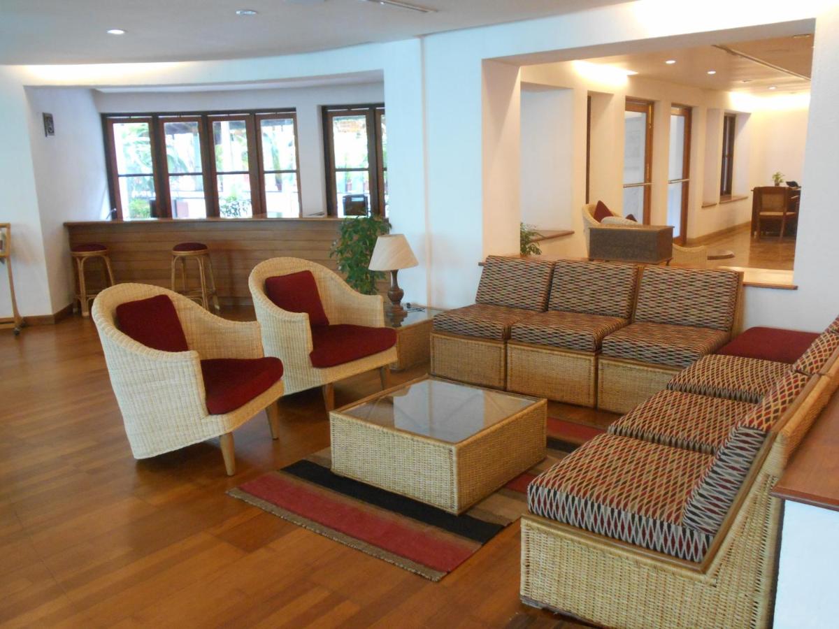 a living room with a couch and chairs at Casino Hotel - CGH Earth, Cochin in Cochin