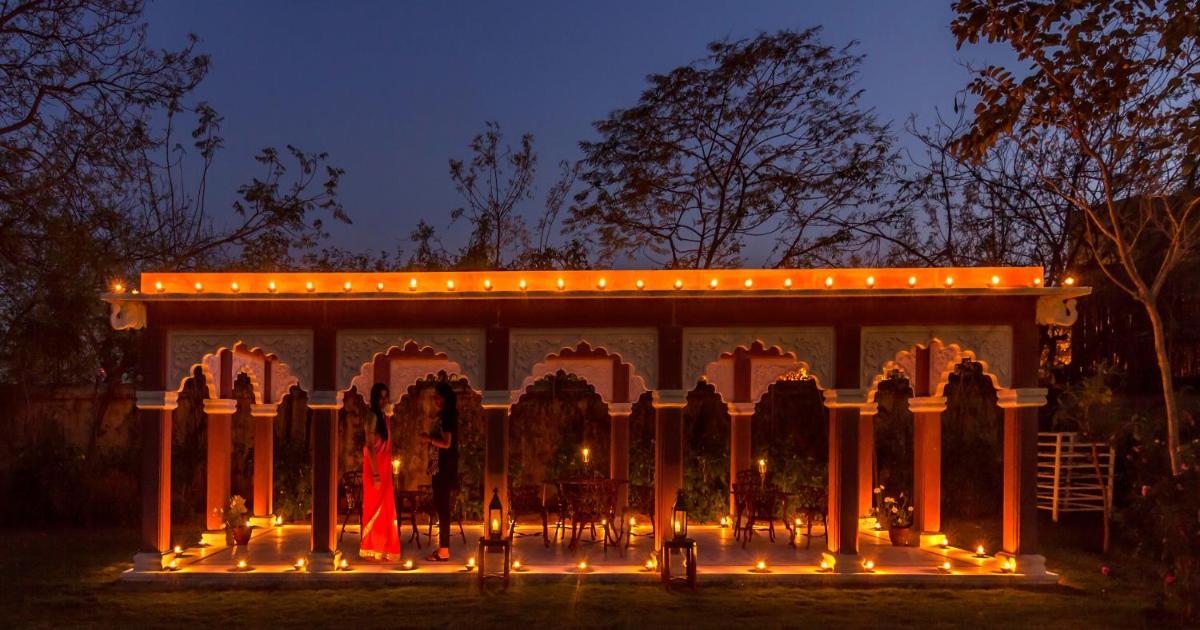 a large building with lights on it at night at Royal Heritage Haveli - By Leisure Hotels in Jaipur