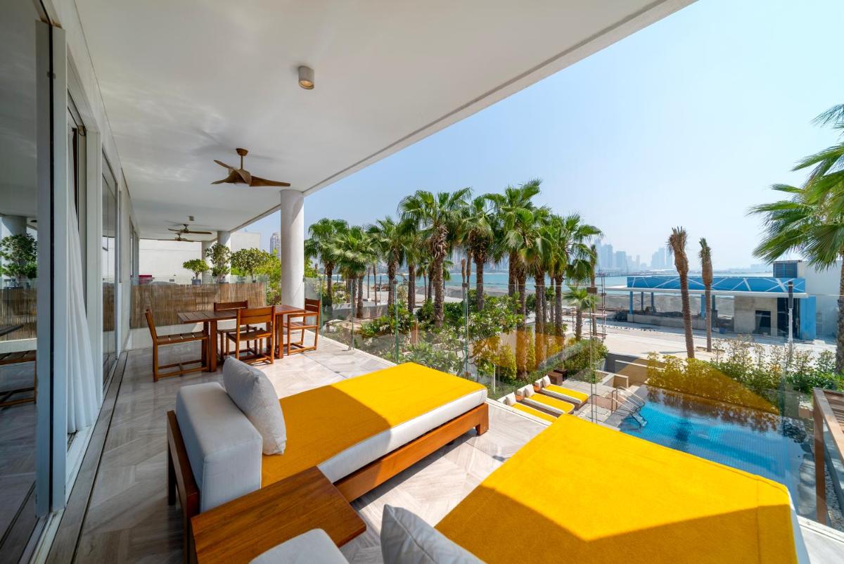 a balcony with a bed and a table and chairs at FIVE Palm Jumeirah Dubai in Dubai