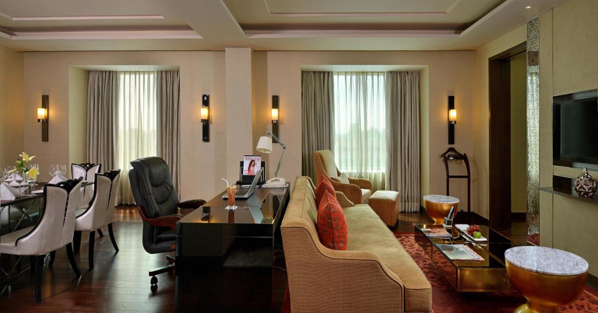 a living room with a couch and a table at Radisson Blu Jaipur in Jaipur