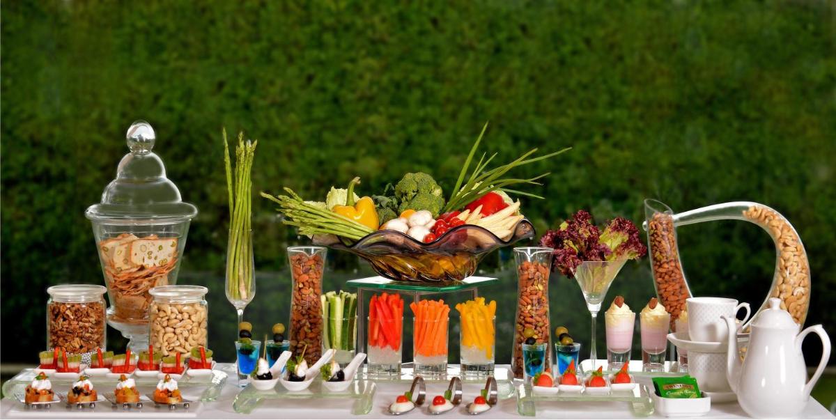 a table with a bunch of different types of food at Radisson Blu Jaipur in Jaipur