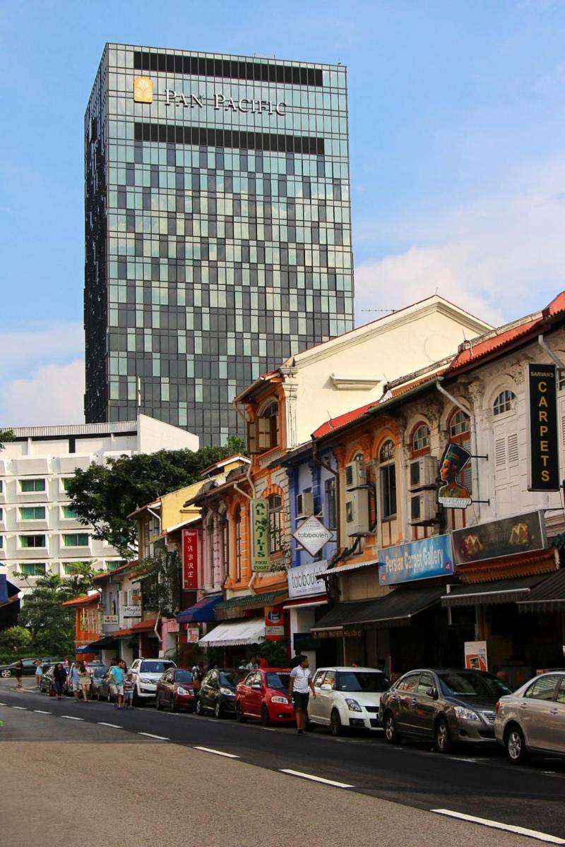 a city street with a tall building in the background at Pan Pacific Serviced Suites Beach Road, Singapore in Singapore a city street with a tall building in the background at Pan Pacific Serviced Suites Beach Road, Singapore in Singapore