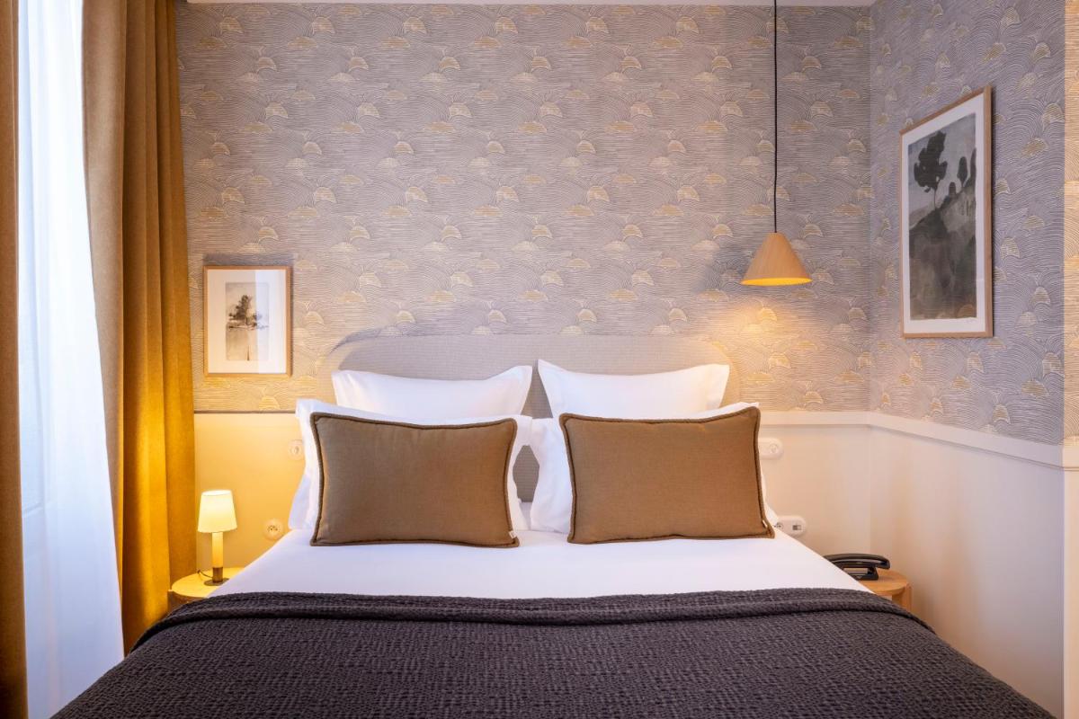 Un ou plusieurs lits dans un hébergement de l'établissement Le Petit Oberkampf Hotel & Spa