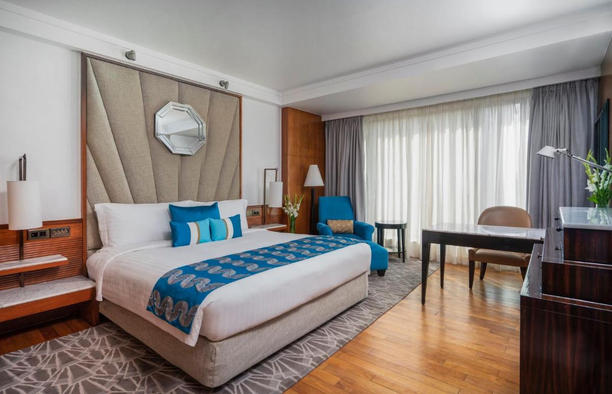 a hotel room with a bed and a desk at InterContinental Marine Drive Mumbai by IHG in Mumbai
