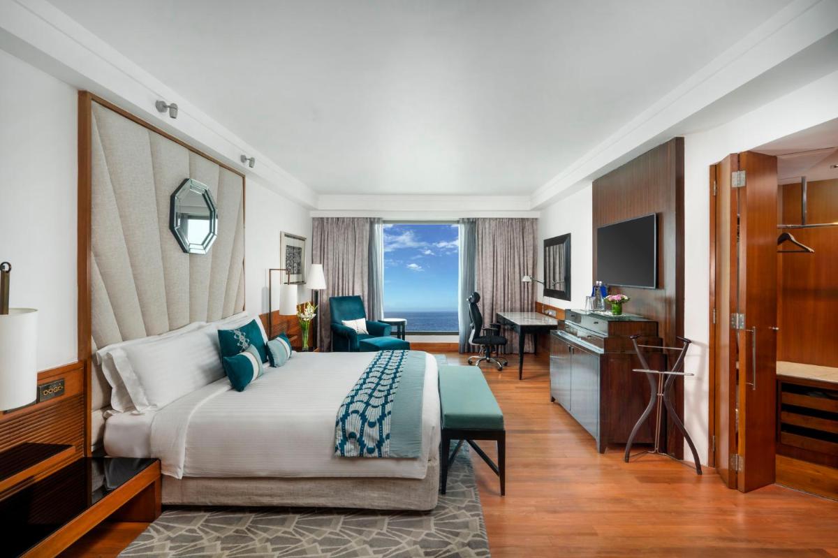 a hotel room with a bed and a desk at InterContinental Marine Drive Mumbai by IHG in Mumbai