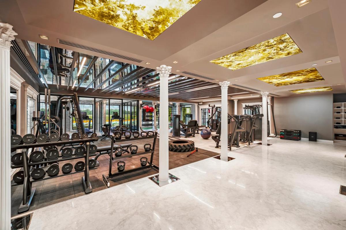 an indoor gym with treadmills and ellipticals at Radisson Blu Hotel & Suites GRT Chennai in Chennai