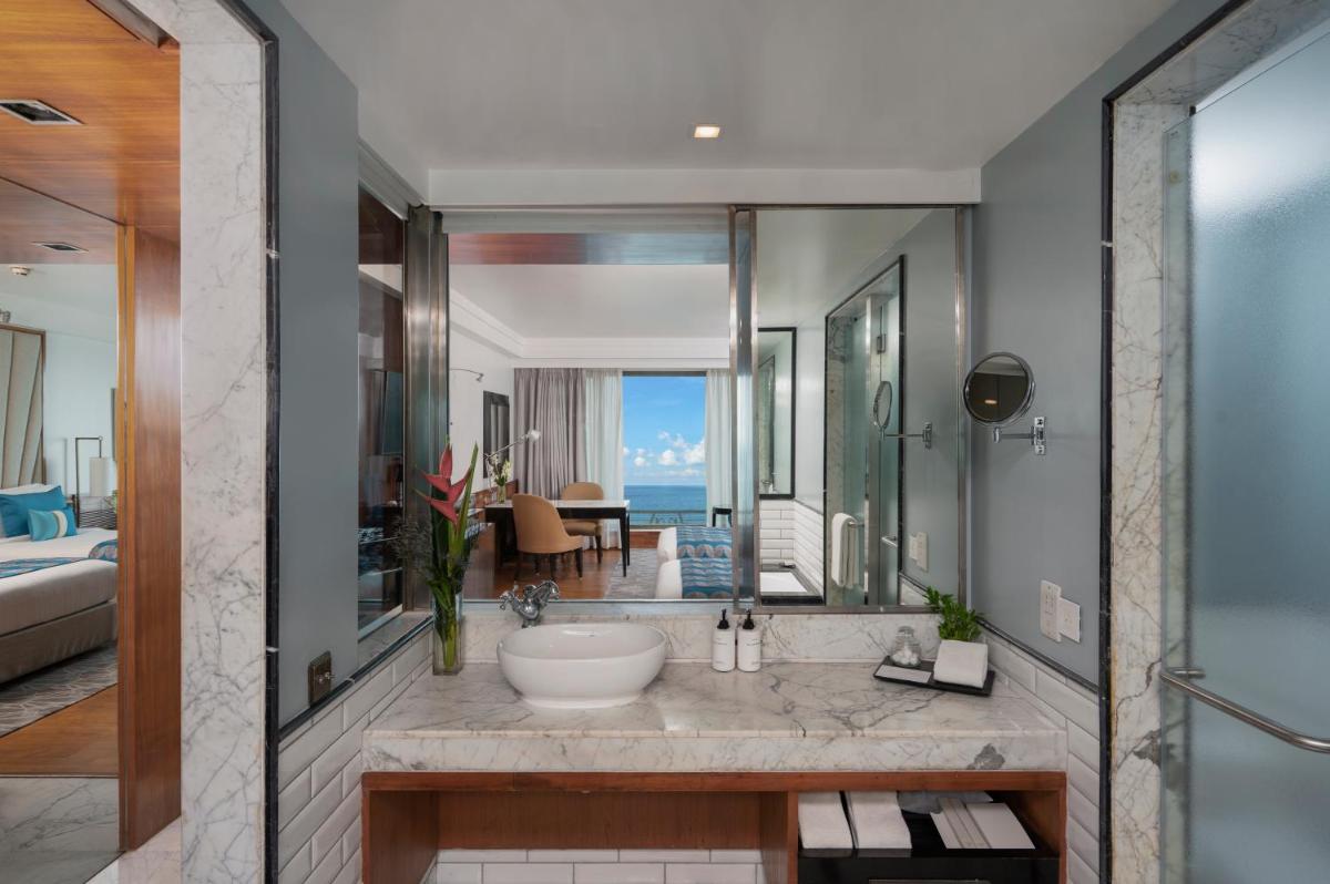 a bathroom with a tub and a sink in a room at InterContinental Marine Drive Mumbai by IHG in Mumbai