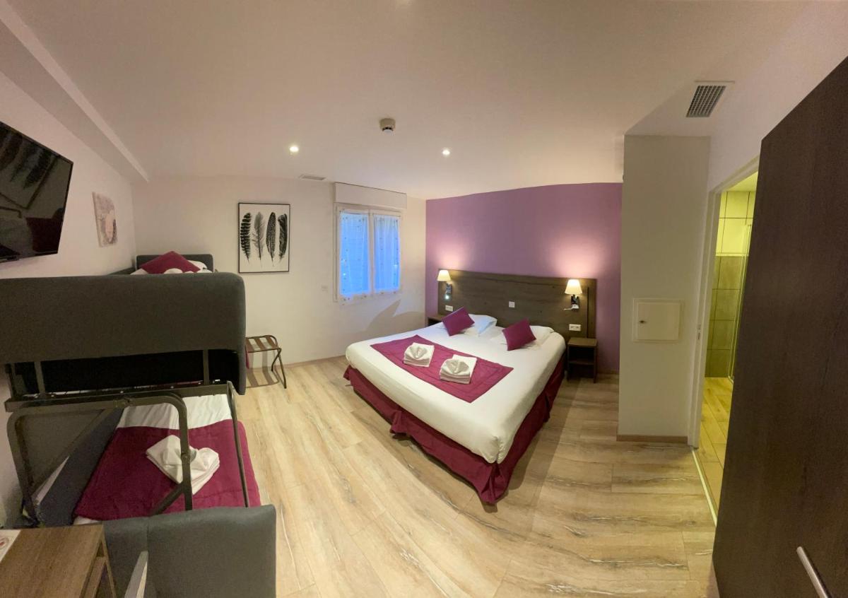 Un ou plusieurs lits dans un hébergement de l'établissement Auberge de la Petite Reine