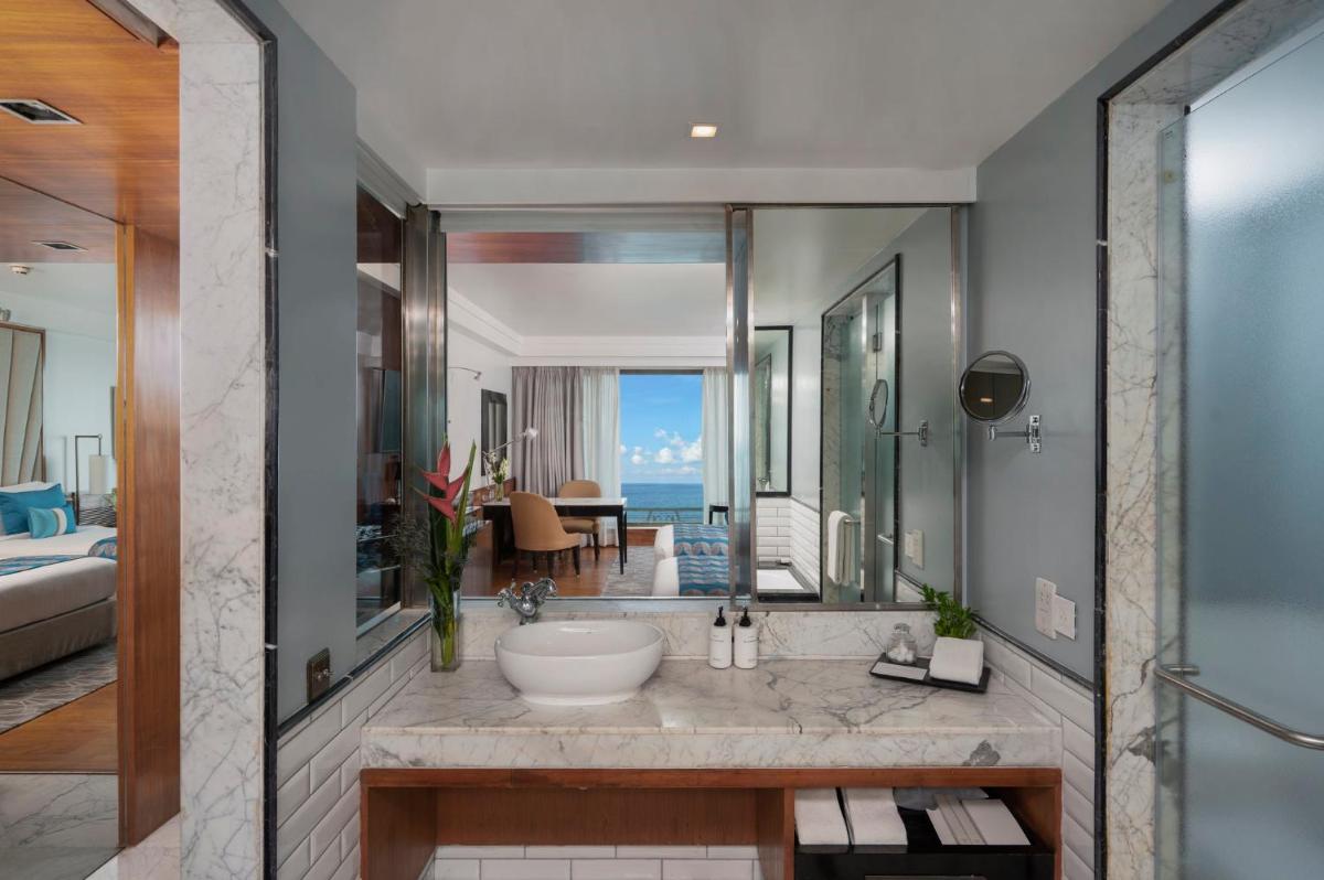 a bathroom with a tub and a sink in a room at InterContinental Marine Drive Mumbai by IHG in Mumbai