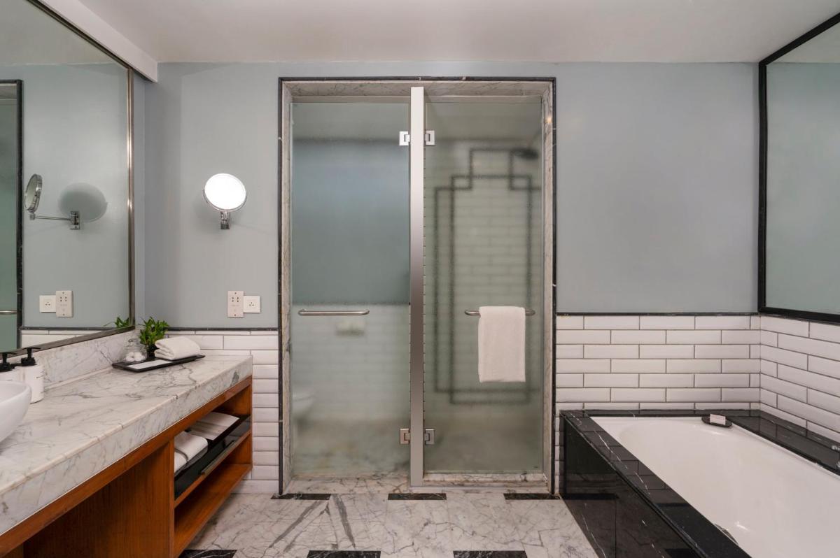 a bathroom with a shower and a bath tub and a bath tub at InterContinental Marine Drive Mumbai by IHG in Mumbai