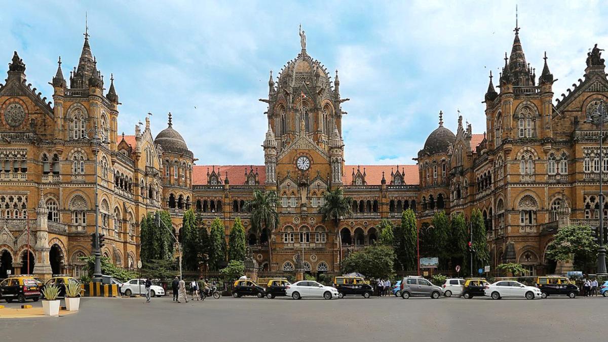 a large building with a clock tower in front of it at InterContinental Marine Drive Mumbai by IHG in Mumbai