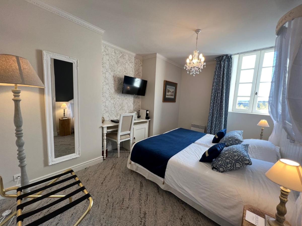 Un ou plusieurs lits dans un hébergement de l'établissement Château Hôtel Edward 1er