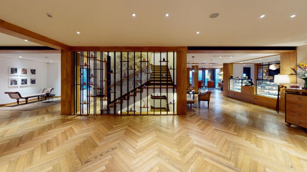 a living room with a staircase in a house at Radisson Hotel Shimla in Shimla
