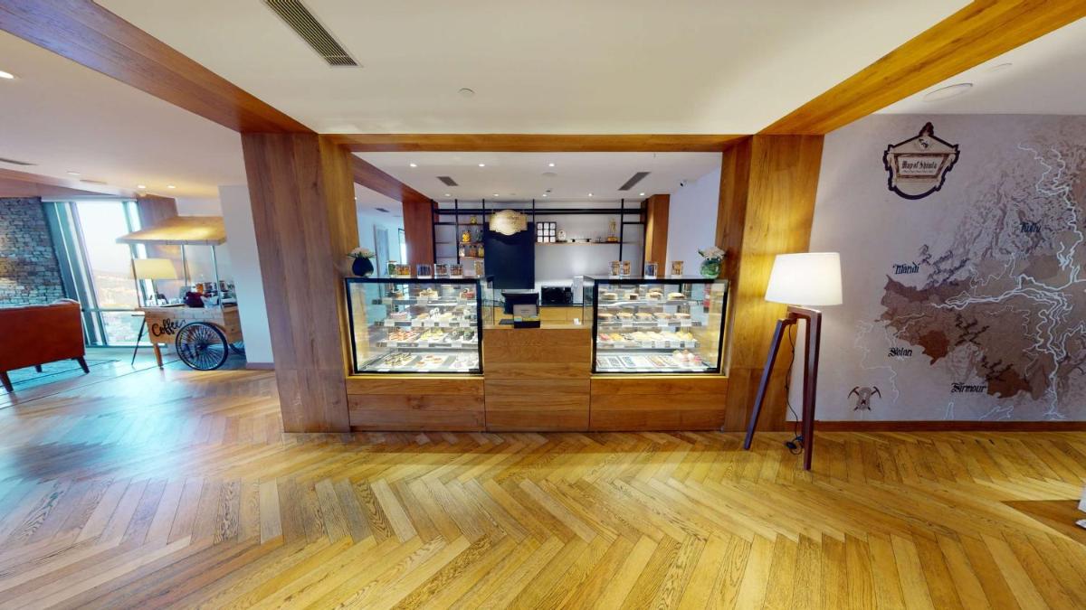 a room with a store with wooden floors and a lamp at Radisson Hotel Shimla in Shimla