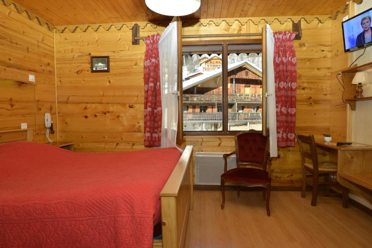 Un ou plusieurs lits dans un hébergement de l'établissement Hotel Le Ferraillon