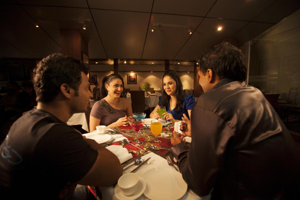 a group of people sitting around a table eating at The Accord Metropolitan in Chennai