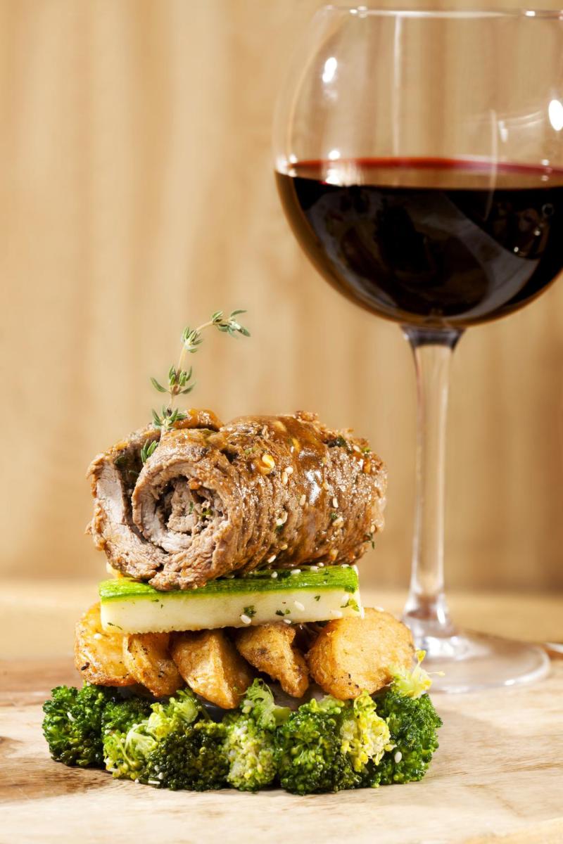 a sandwich sitting next to a glass of wine at The Accord Metropolitan in Chennai