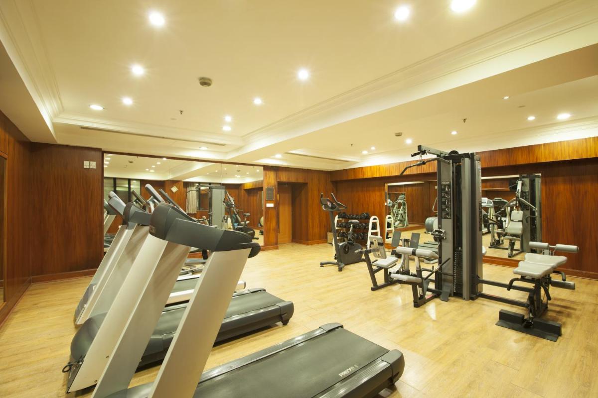 a gym with several treadmills and exercise bikes at The Accord Metropolitan in Chennai