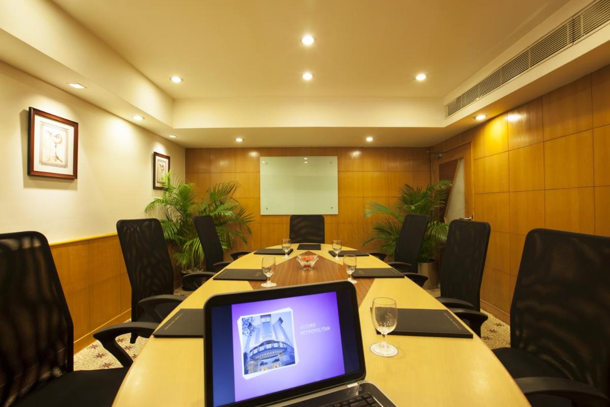 a conference room with a table with a laptop on it at The Accord Metropolitan in Chennai