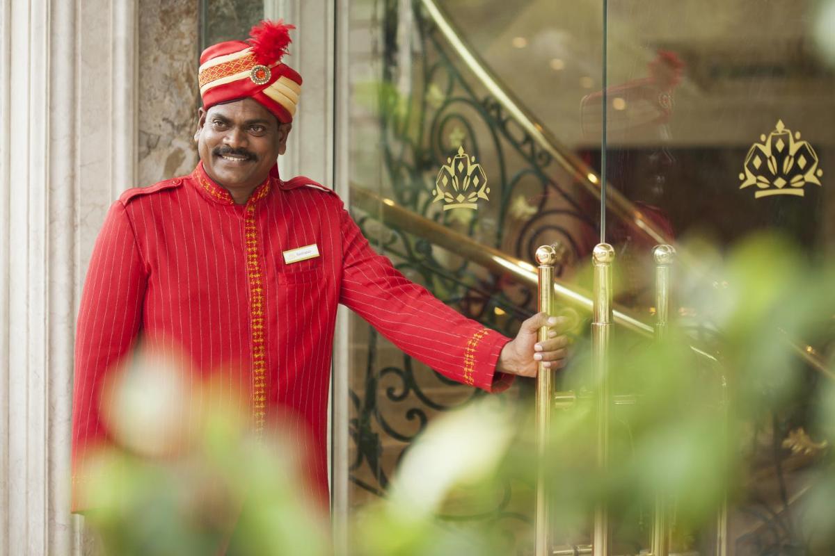 a man in a red outfit holding an umbrella at The Accord Metropolitan in Chennai