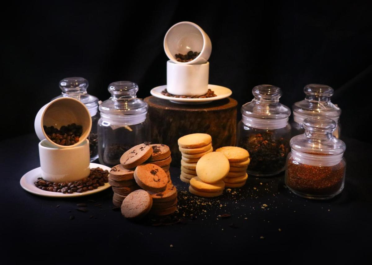 a table topped with cookies and jars of food at Crowne Plaza Pune City Centre by IHG in Pune