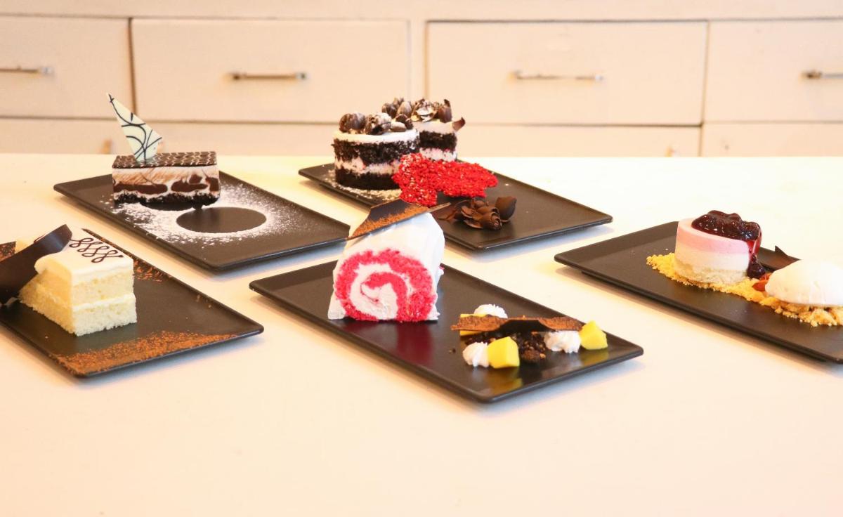 a group of desserts on plates on a table at Crowne Plaza Pune City Centre by IHG in Pune