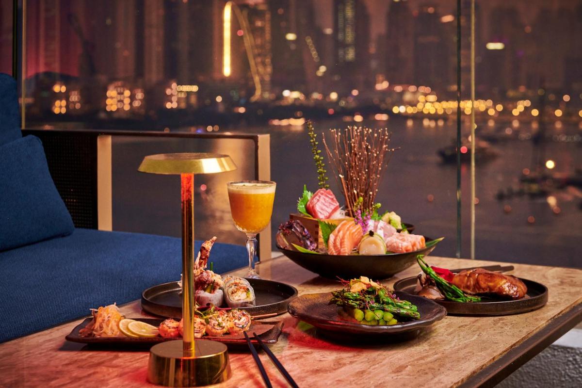 a table with food and a glass of beer on it at FIVE Palm Jumeirah Dubai in Dubai a table with food and a glass of beer on it at FIVE Palm Jumeirah Dubai in Dubai