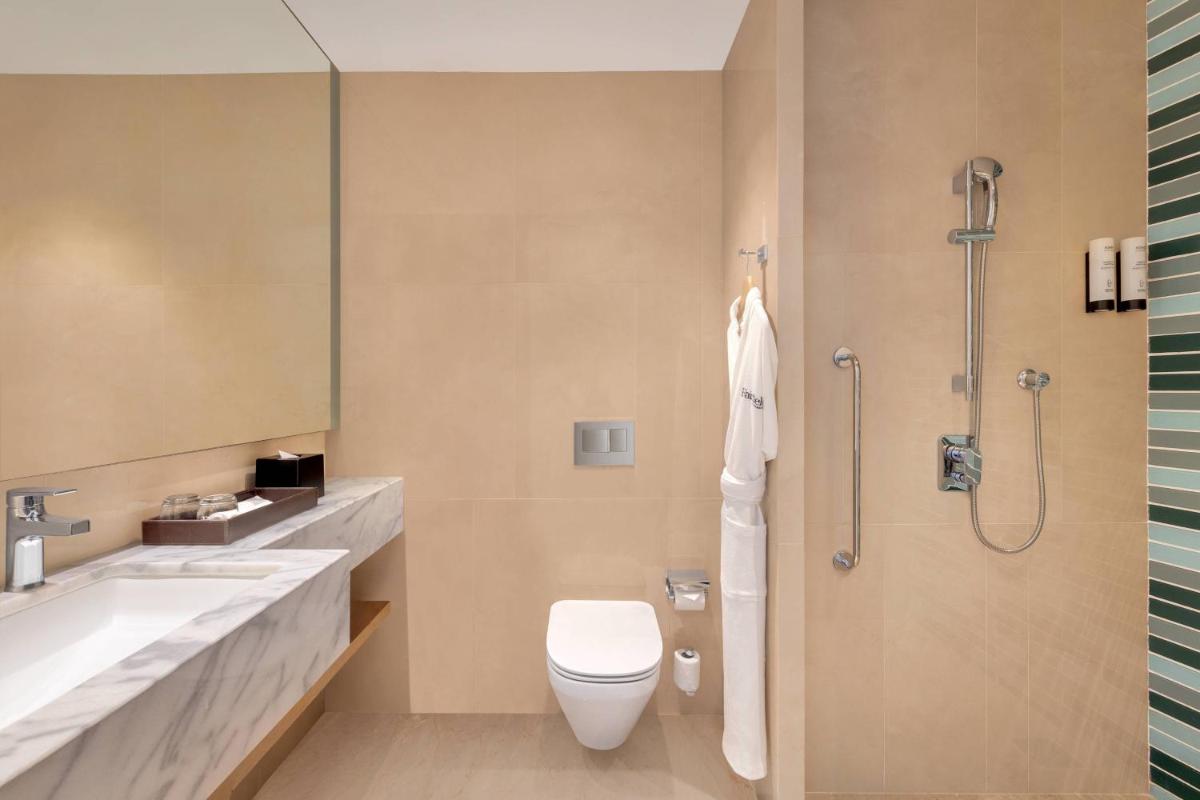 a bathroom with a toilet and a sink and a shower at Fairfield by Marriott Dehradun in Dehradun