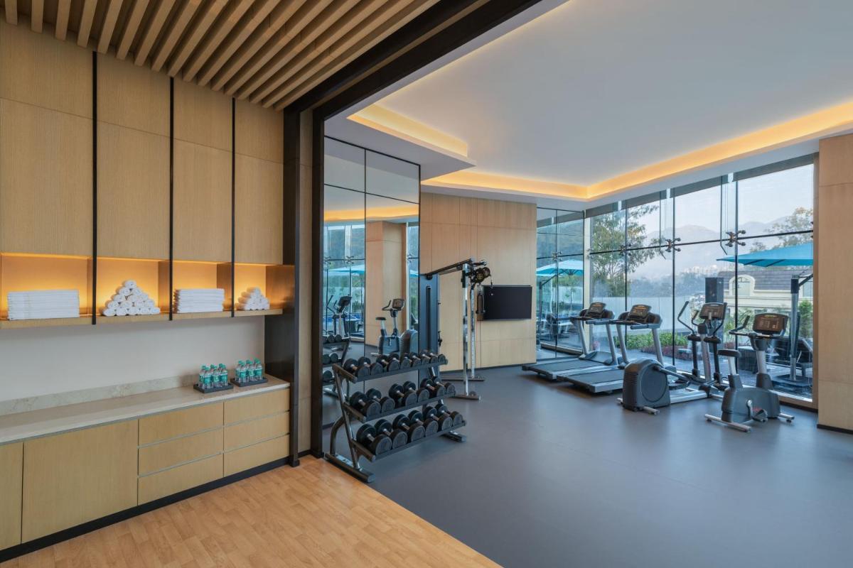 a gym with treadmills and cardio equipment in a building at Fairfield by Marriott Dehradun in Dehradun