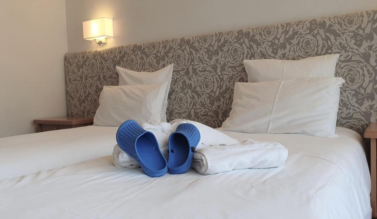 Un ou plusieurs lits dans un hébergement de l'établissement Hôtel Macchi Restaurant & Spa