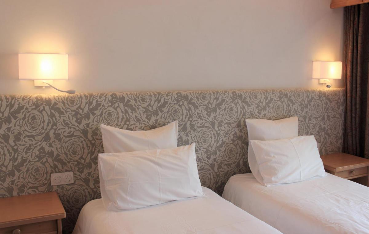 Un ou plusieurs lits dans un hébergement de l'établissement Hôtel Macchi Restaurant & Spa