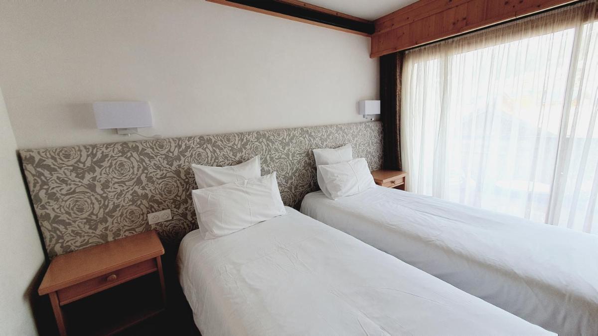 Un ou plusieurs lits dans un hébergement de l'établissement Hôtel Macchi Restaurant & Spa
