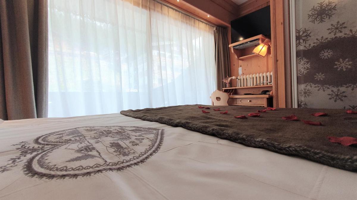 Un ou plusieurs lits dans un hébergement de l'établissement Hôtel Macchi Restaurant & Spa