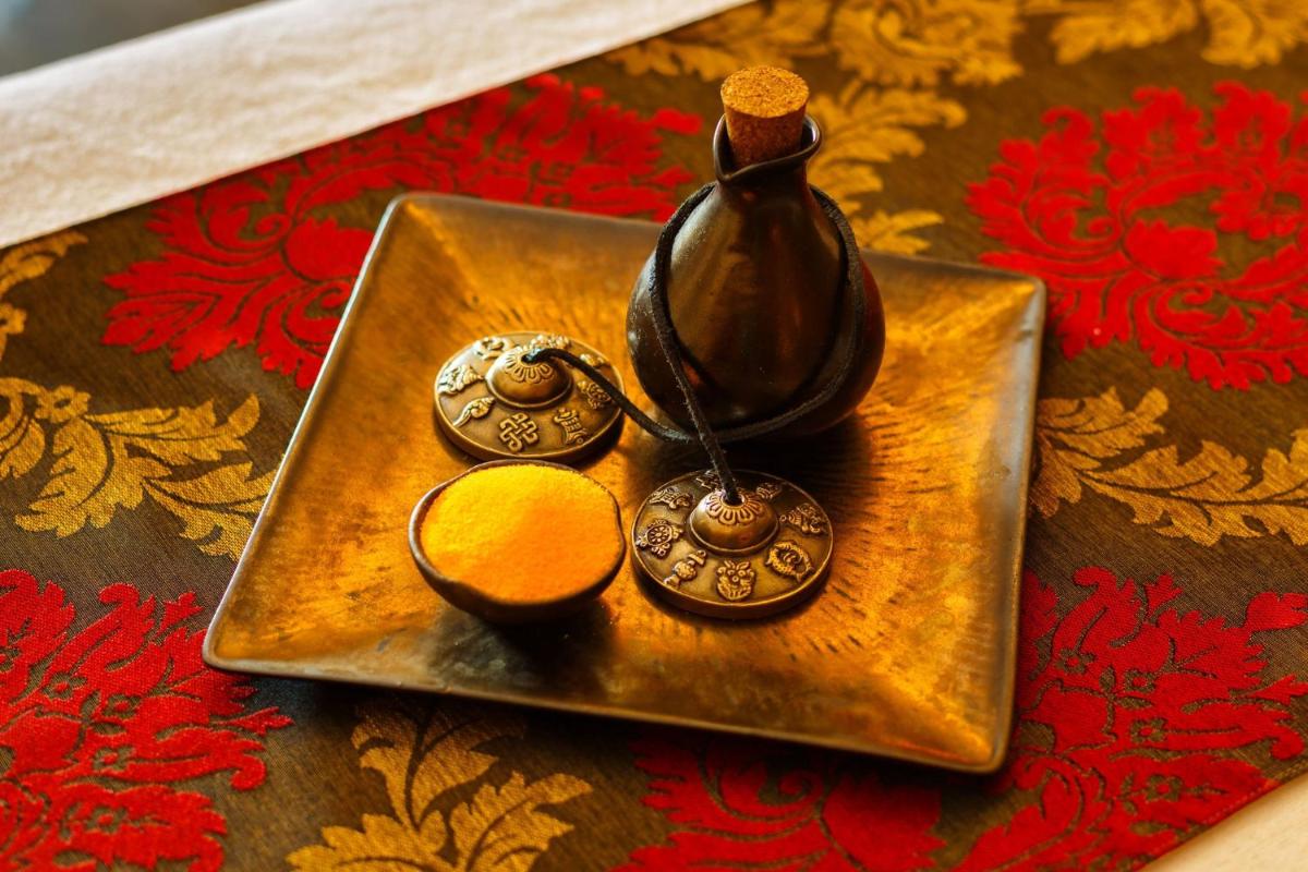 a gold plate with a vase on a table at Crowne Plaza Ahmedabad City Centre by IHG in Ahmedabad