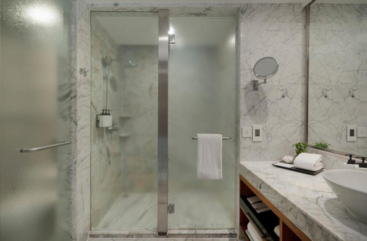 a bathroom with a shower and a sink at InterContinental Marine Drive Mumbai by IHG in Mumbai